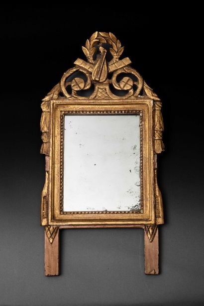 Wooden mirror decorated with musical instruments,...