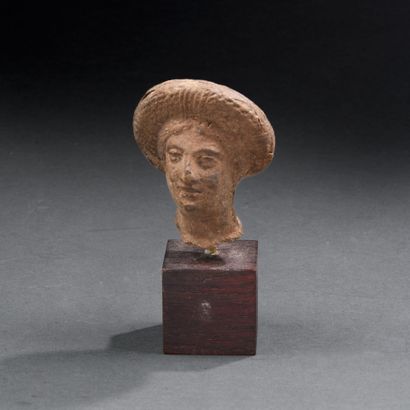 Roman period
Female head wearing a thick...