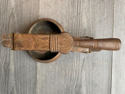 An antique metal cooking utensil for leathering...