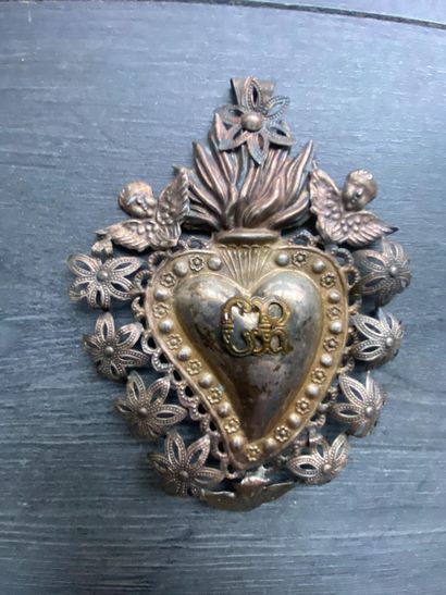 Un écusson en métal détouré en forme de coeur...