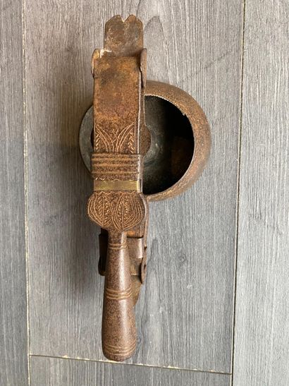An antique metal cooking utensil for leathering...