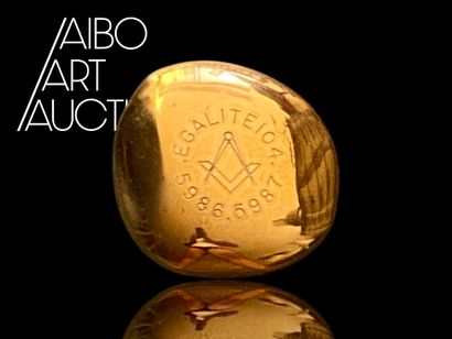 Small pebble-shaped paperweight in gilded...