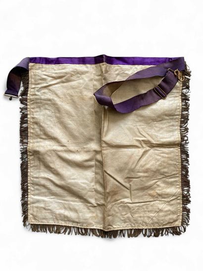 A silk apron with purple borders and gold...