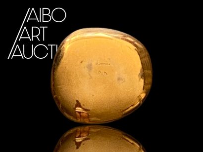 Small pebble-shaped paperweight in gilded...