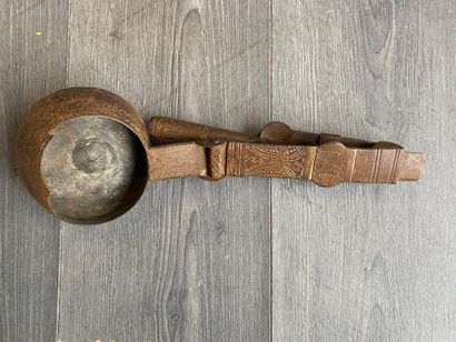 An antique metal cooking utensil for leathering...