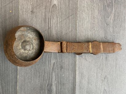 An antique metal cooking utensil for leathering...