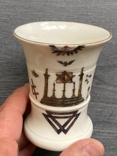 A porcelain goblet with gilded rim and painted...
