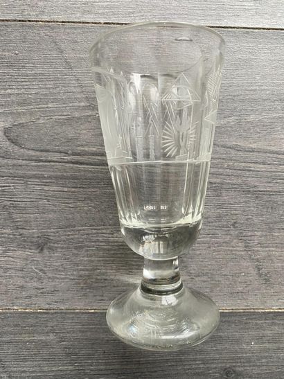 Flared stemmed glass with symbols of the...