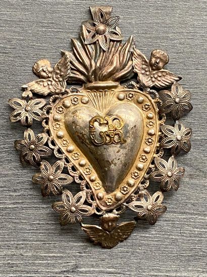 Un écusson en métal détouré en forme de coeur...