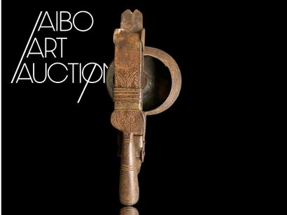 An antique metal cooking utensil for leathering...