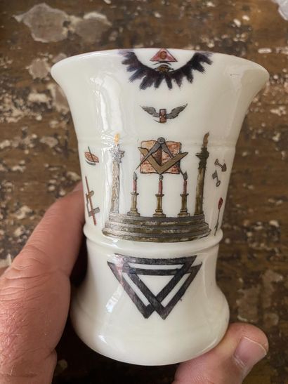 A porcelain goblet with gilded rim and painted...