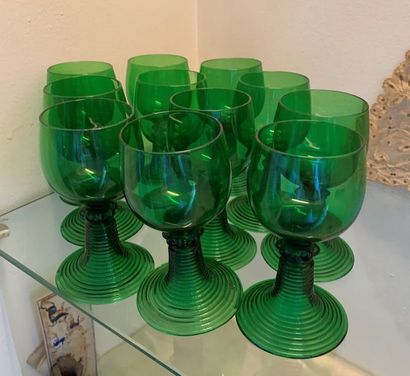 Eleven Römer in green tinted glass. The striated...