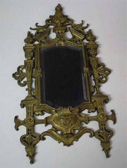 A bevelled mirror with a Renaissance style...