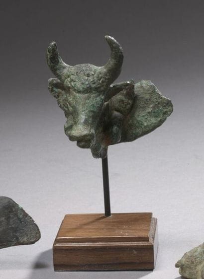 A bull protome coming out of a crescent moon,...
