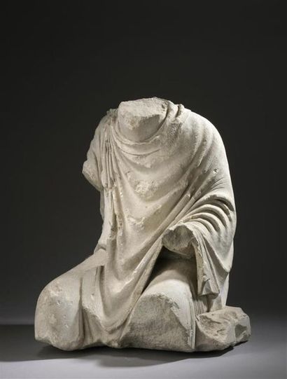 Sitting male statue. The figure is dressed...