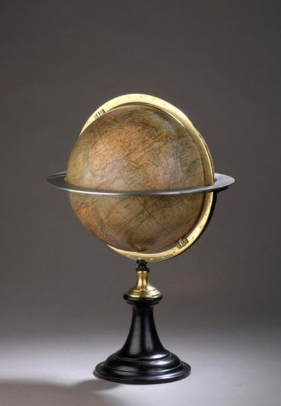 Engraved and colored paper globe. Divided...