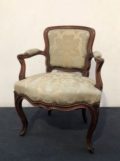 Fauteuil bas en noyer mouluré et sculpté...