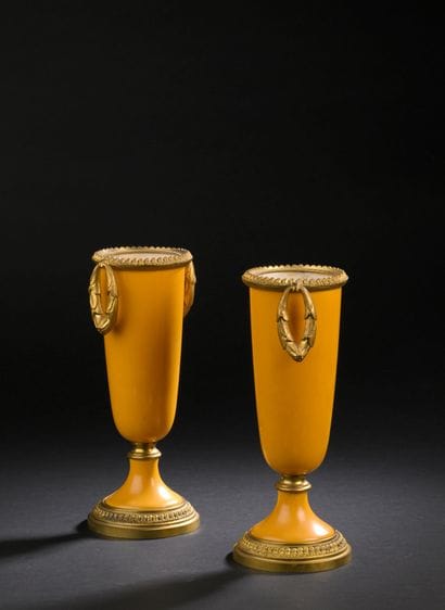 Pair of urn vases on pedestal in yellow porcelain...
