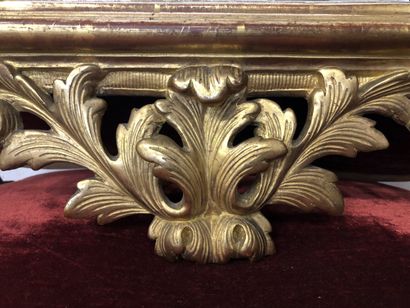 Mirror in a pedimented frame in gilded wood...