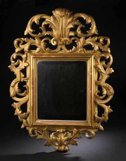 Mirror in a pedimented frame in gilded wood...