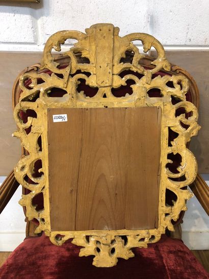 Mirror in a pedimented frame in gilded wood...