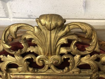 Mirror in a pedimented frame in gilded wood...