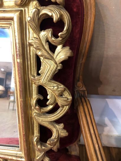 Mirror in a pedimented frame in gilded wood...
