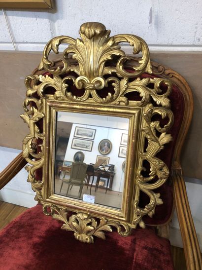 Mirror in a pedimented frame in gilded wood...