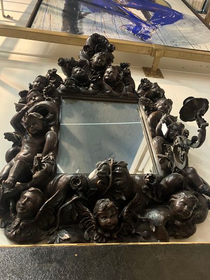 Mirror in a large resin wood frame, richly...