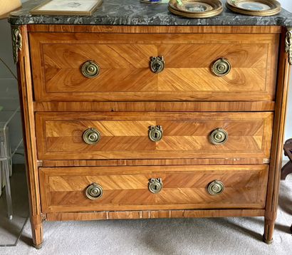 A satin-finish veneered COMMODE opening with...