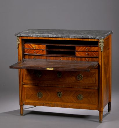 A satin-finish veneered COMMODE opening with...