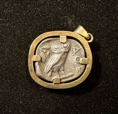Pendant containing an antique silver coin:
ATTIC...