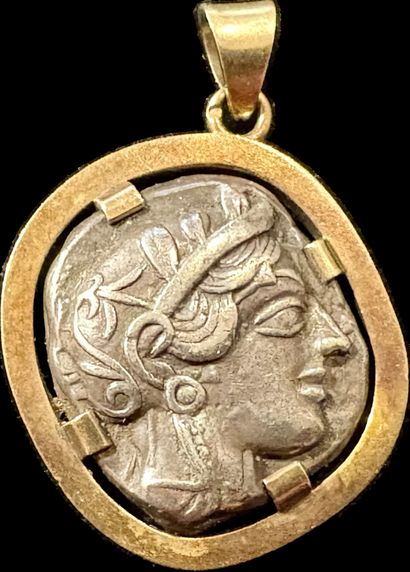 Pendant containing an antique silver coin:
ATTIC...