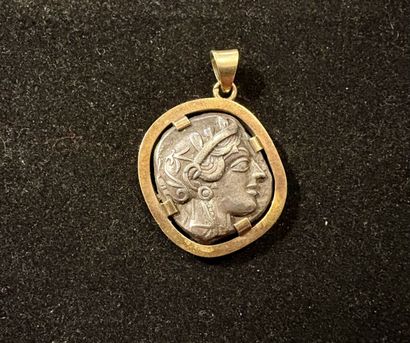 Pendant containing an antique silver coin:
ATTIC...