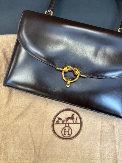 Hermès Paris
Envelope-shaped handbag in brown...