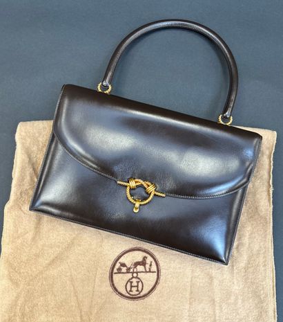 Hermès Paris
Envelope-shaped handbag in brown...