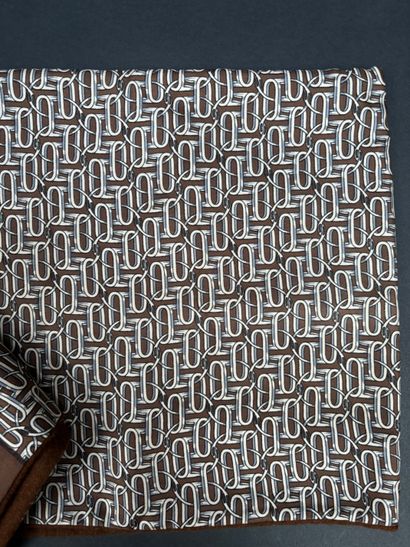 Hermès 
Brown silk scarf with ring motif,...