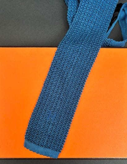 Hermès Paris
Blue silk knit tie, monogrammed...