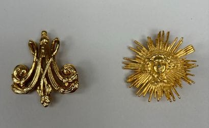 RMN 
Set of two engraved gilt metal brooches...
