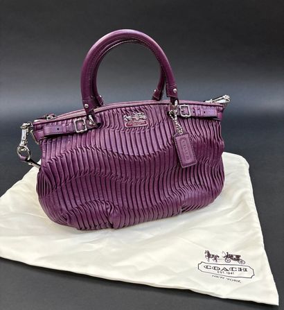 Coach
Purple pleated leather bag.
Double...