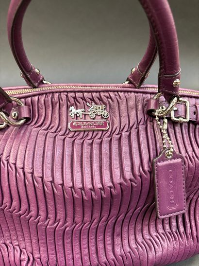 Coach
Purple pleated leather bag.
Double...