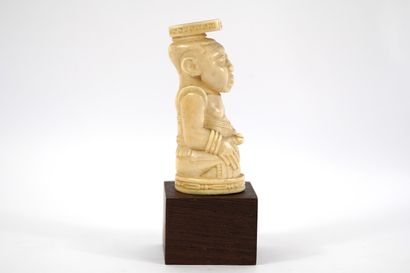 African bone sculpture on base. Democratic...