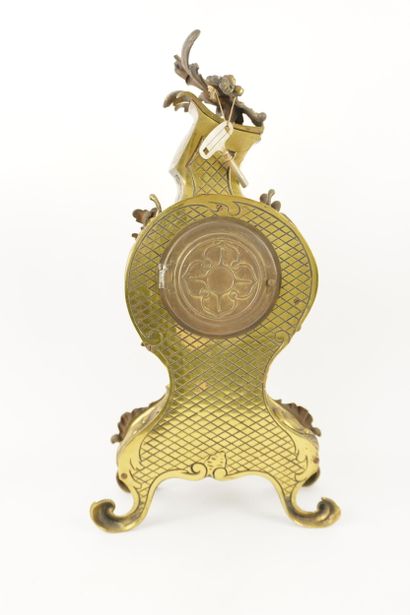 Bronze mantelpiece.
Clock and its two six-light...