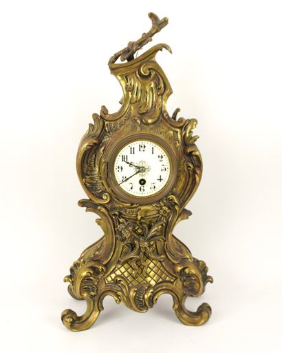 Bronze mantelpiece.
Clock and its two six-light...