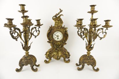 Bronze mantelpiece.
Clock and its two six-light...