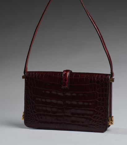 Brown crocodile-style leather handbag.
Twisted...