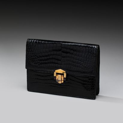 Black crocodile-effect leather clutch. 
Gilded...
