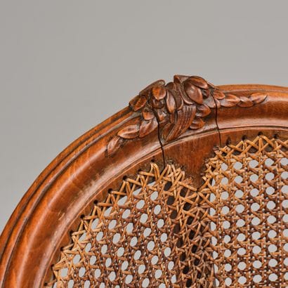 Cane-seated office chair made of molded and...