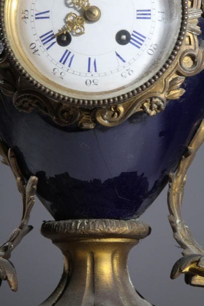 Bronze and metal clock with a case shaped...