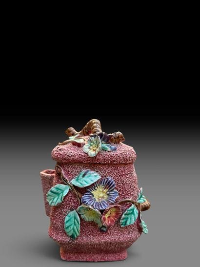 Glazed earthenware box with an appliqué design...